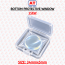 Abdul Traders AT 15KW protective window for fiber laser cutting heads, 34mm diameter and 5mm thickness in a case.