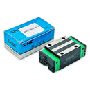 Abdul Traders SHAC QHH 15CA CNC linear guide block with green casing and metal rail interface next to its blue box