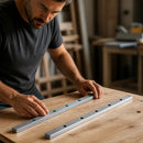 Abdul Traders technician inspecting two SHAC GER 25-4000 precision linear guide rails on a wooden workbench