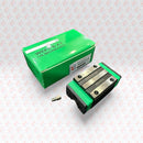 Abdul Traders WERB HGH 15CA linear guide block, a compact carriage for 15mm rails, with green accents and metal components.